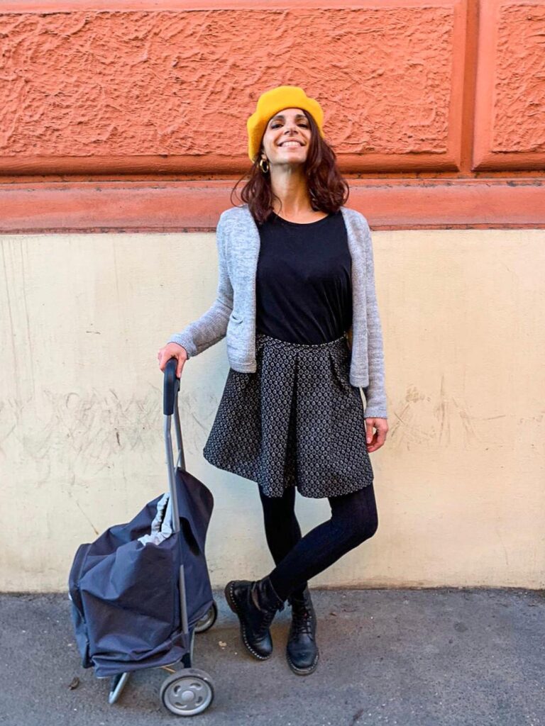 smiling girl with a yellow hat going shopping in Rome