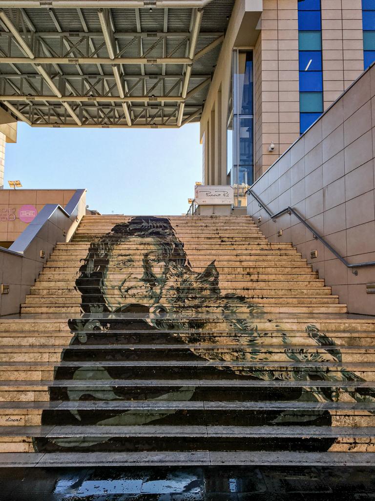 staircase with Anna Magnani picture outside Trionfale Market in Rome