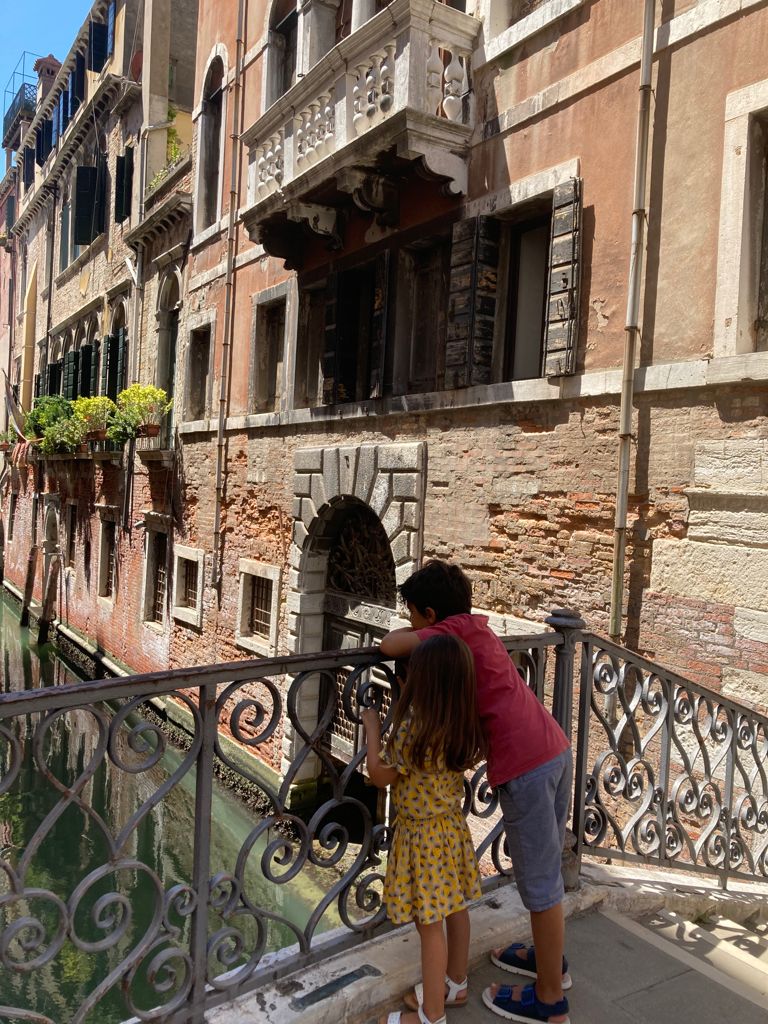 kids pictured from the back on a bridge