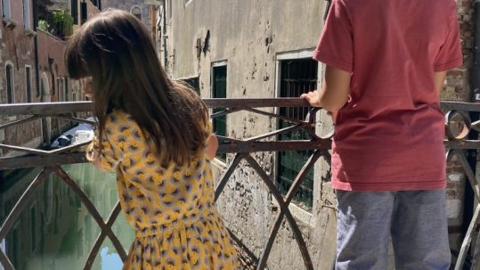 kids on a bridge in Venice